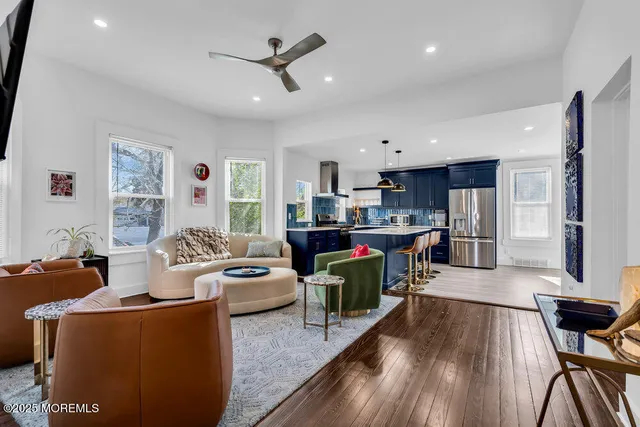 a living room with furniture and a wooden floor