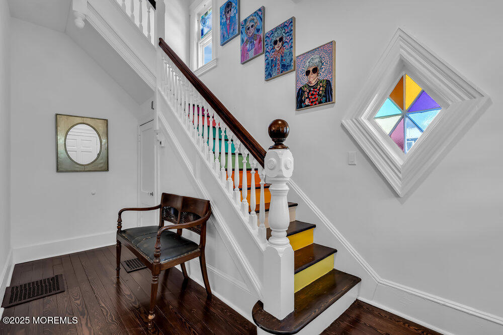 1200 Sunset Avenue Asbury Park, NJ 07712 - Photo 32 of 57 a view of staircase with lots of frames on wall and a painting on the wall