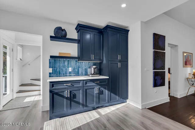 a kitchen with stainless steel appliances granite countertop a stove a refrigerator and a wooden cabinets