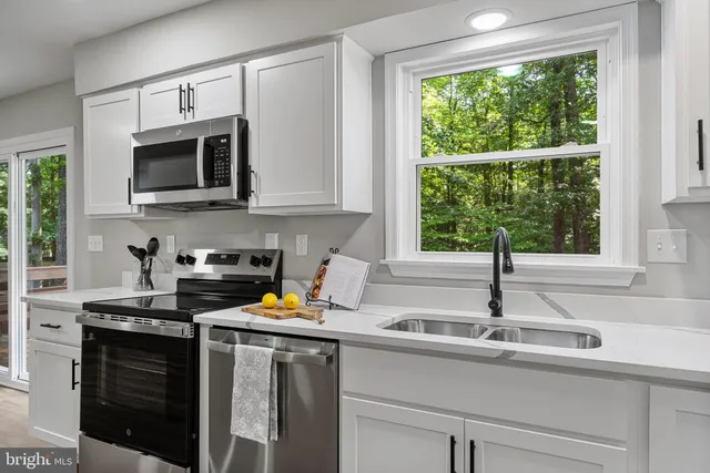 a kitchen with a sink stove and microwave
