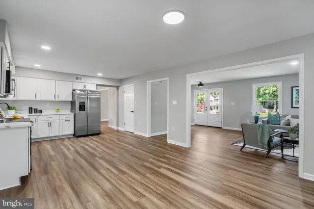 a view of a kitchen with furniture and wooden floor