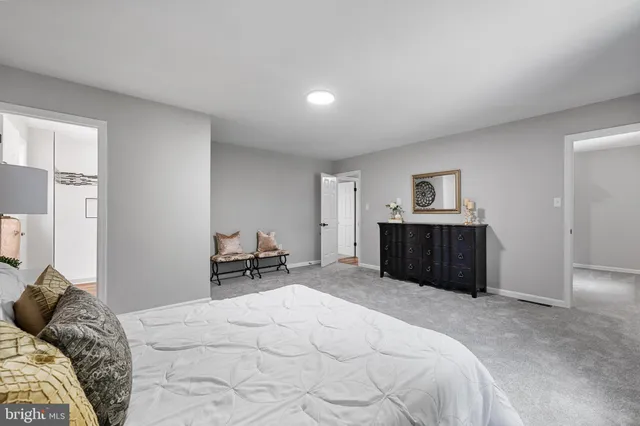 a bedroom with a bed and a chair