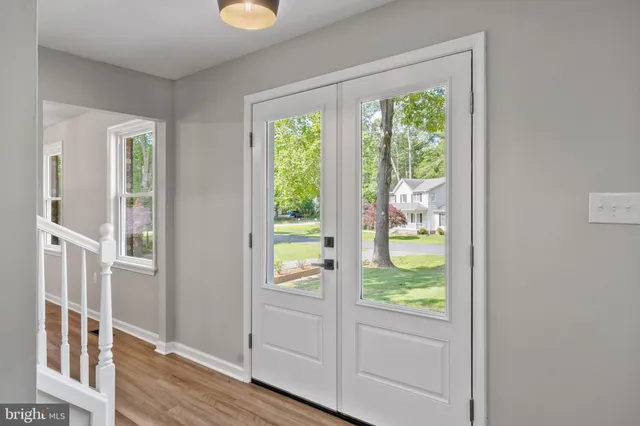 a view of an entryway with wooden floor and windows