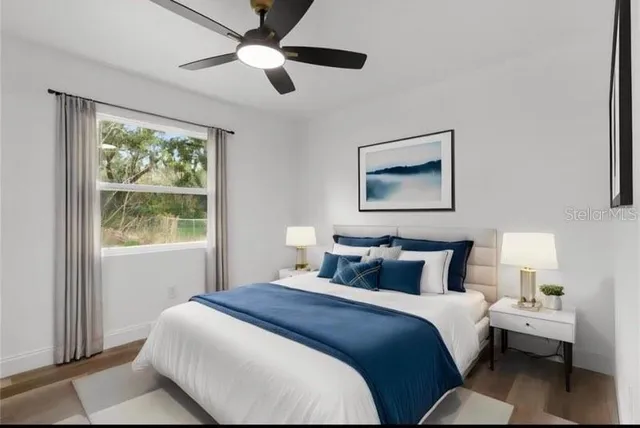 a bedroom with a large bed and a window