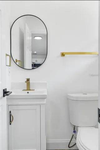 a bathroom with a sink a mirror and a toilet