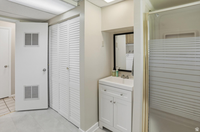 8938 Manchester Lane Sandy, UT 84093 - Photo 31 of 50 Bathroom featuring a white vanity with integrated sink, framed mirror, and a shower with a frosted glass screen