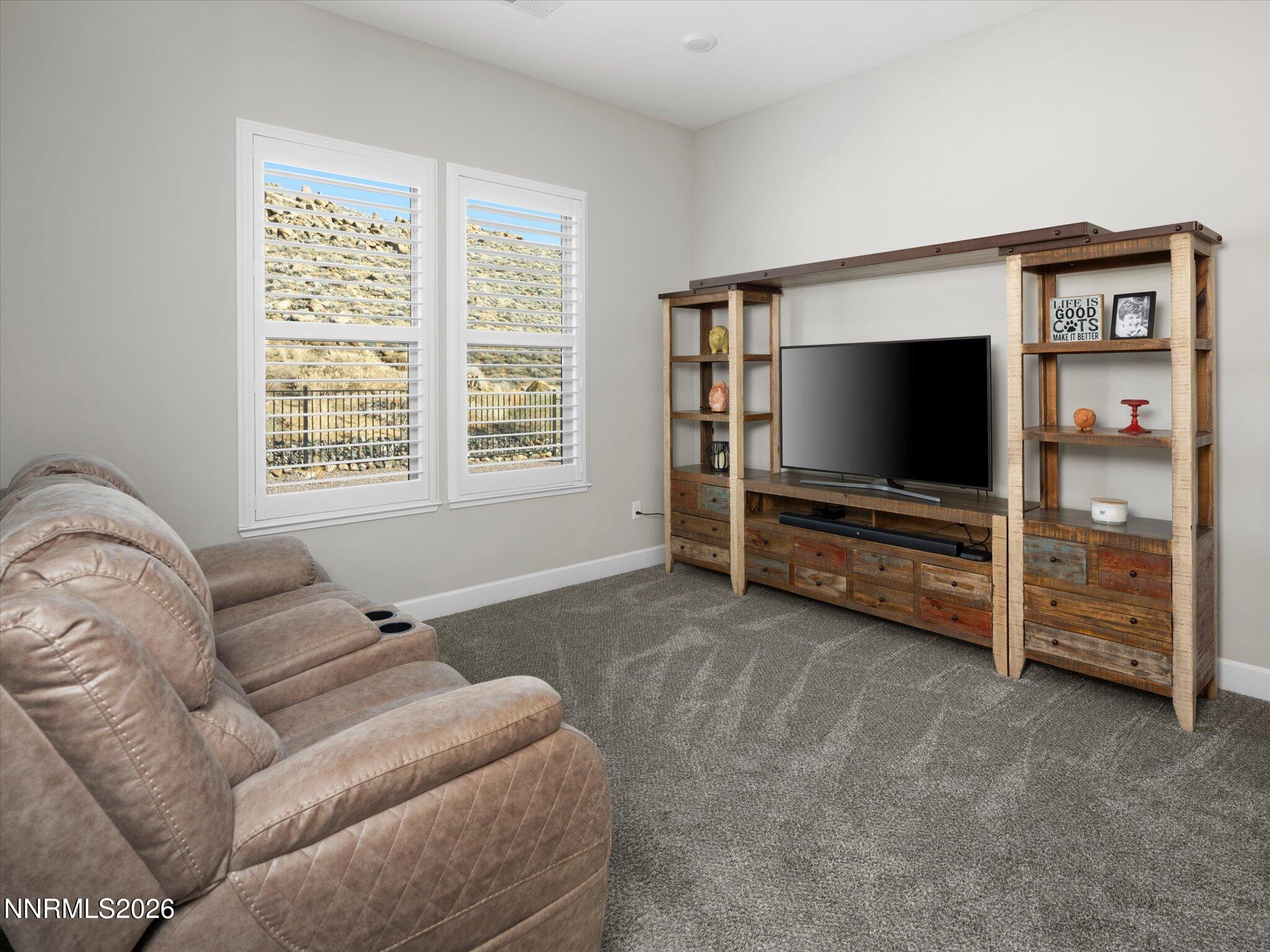 415 Gooseberry Drive Reno, NV 89523 - Photo 11 of 32 a living room with furniture and a flat screen tv