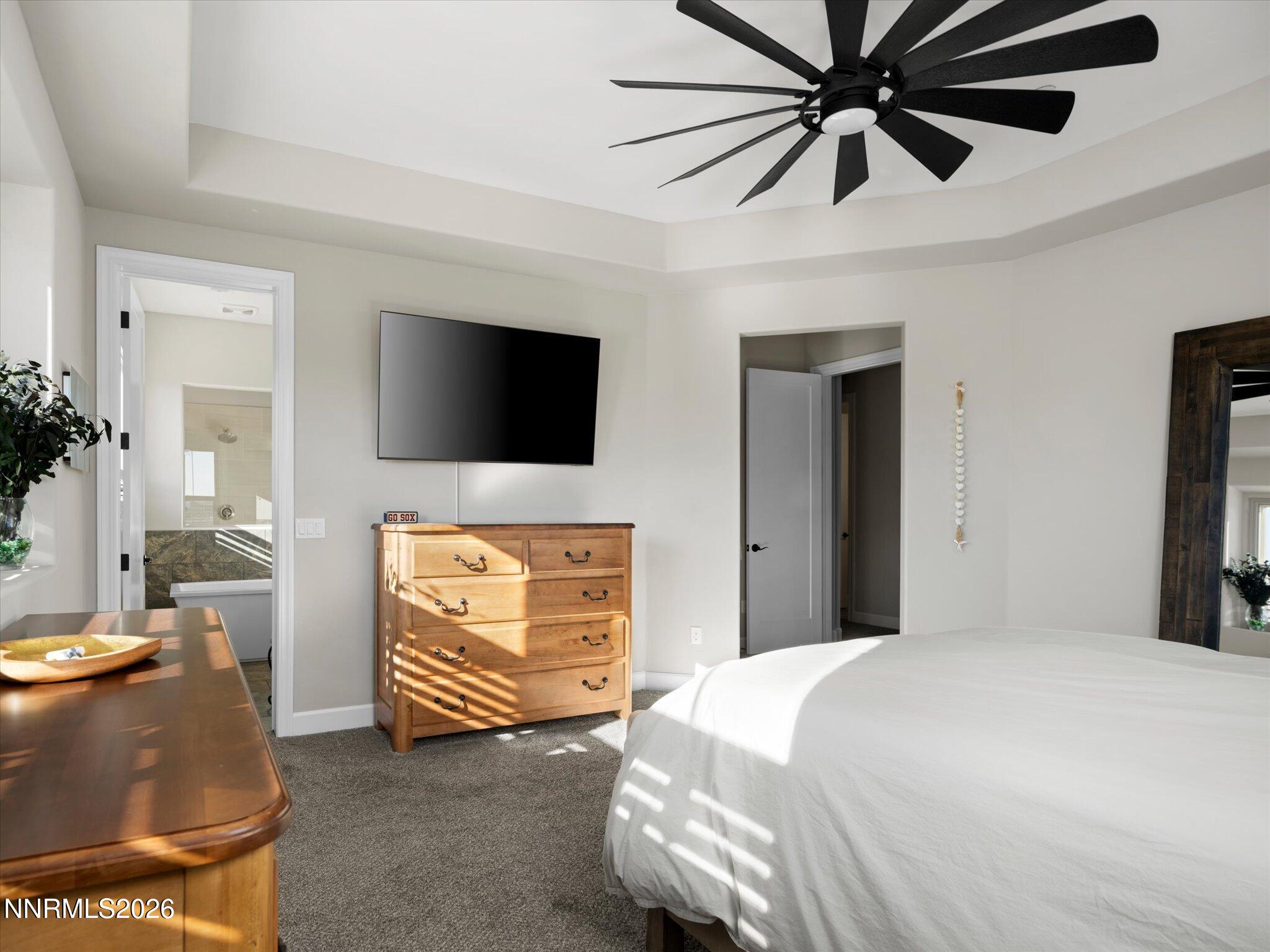 415 Gooseberry Drive Reno, NV 89523 - Photo 16 of 32 a bedroom with a bed and a flat screen tv