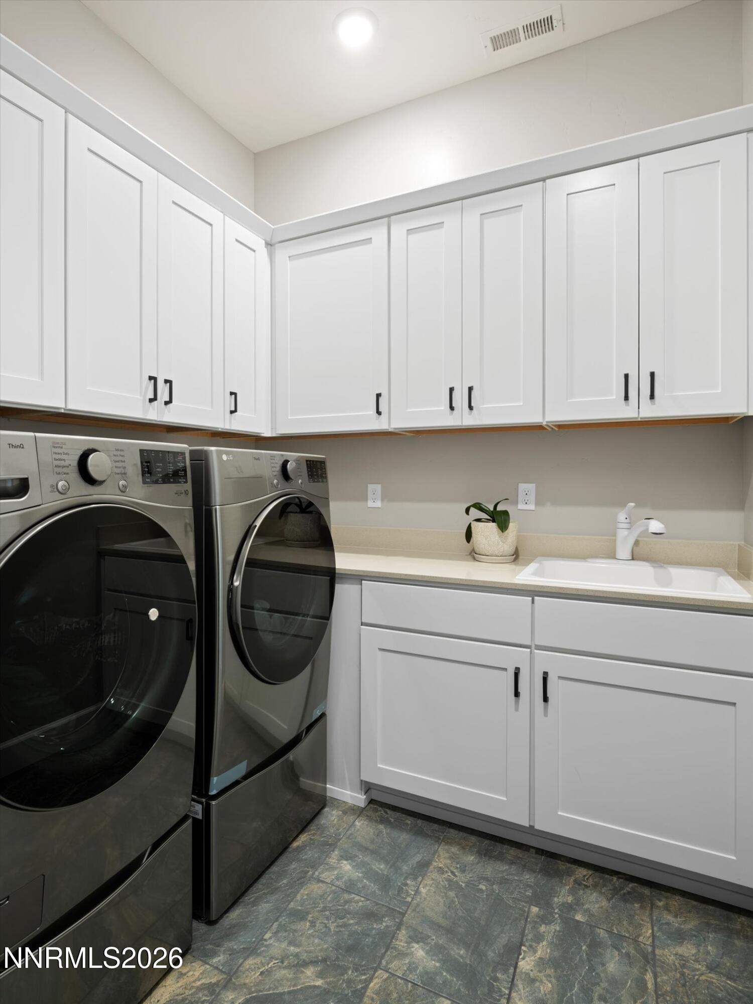 415 Gooseberry Drive Reno, NV 89523 - Photo 19 of 32 a utility room with stainless steel appliances granite countertop a sink and cabinets