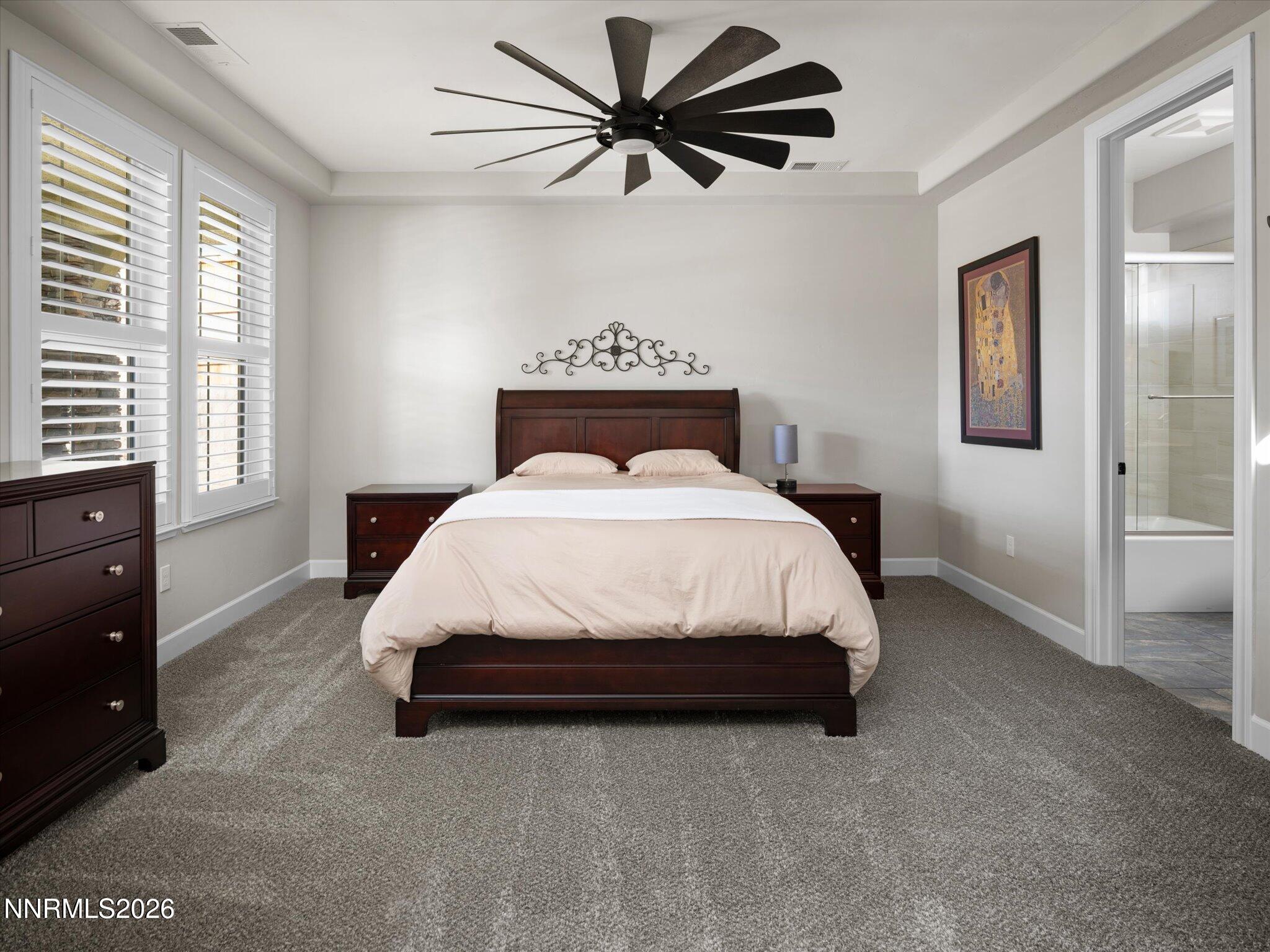 415 Gooseberry Drive Reno, NV 89523 - Photo 23 of 32 a bedroom with a bed and a chandelier