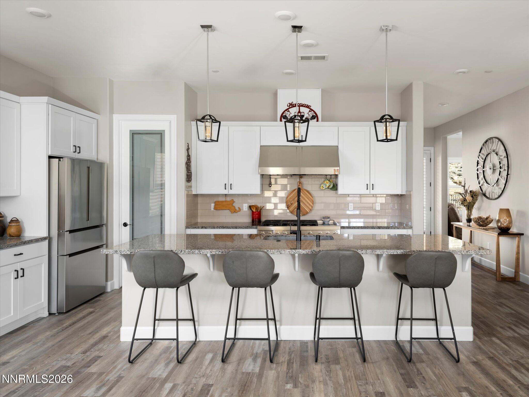 415 Gooseberry Drive Reno, NV 89523 - Photo 5 of 32 a kitchen with stainless steel appliances kitchen island a refrigerator and a stove