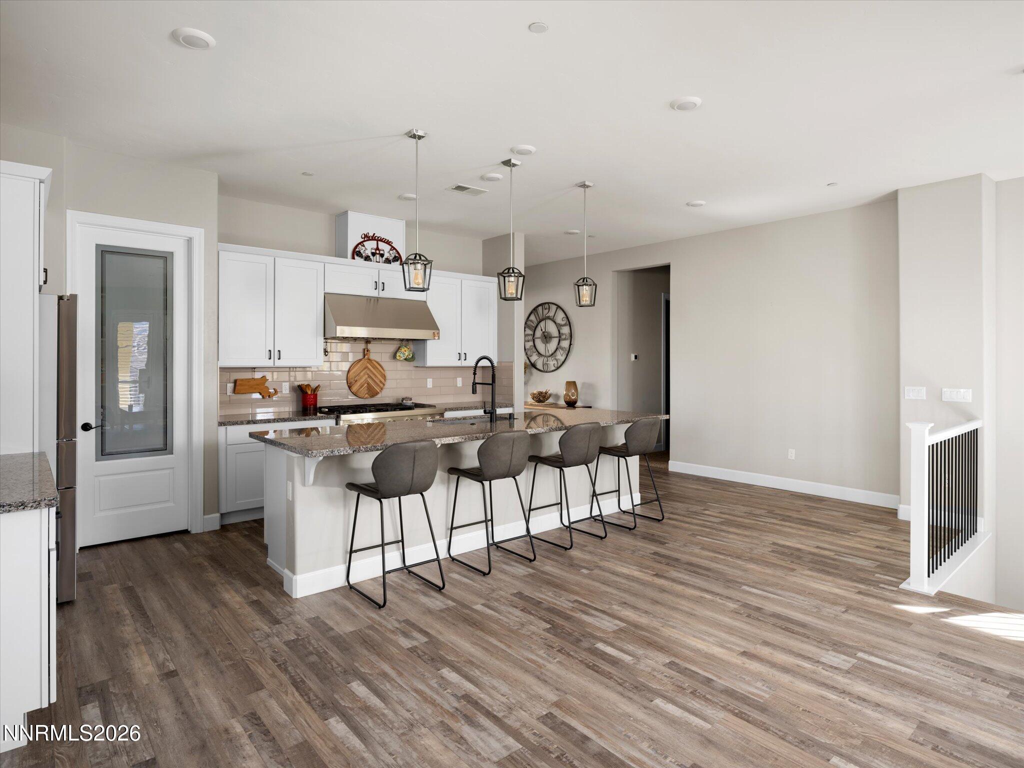 415 Gooseberry Drive Reno, NV 89523 - Photo 6 of 32 a living room with furniture a flat screen tv and kitchen view
