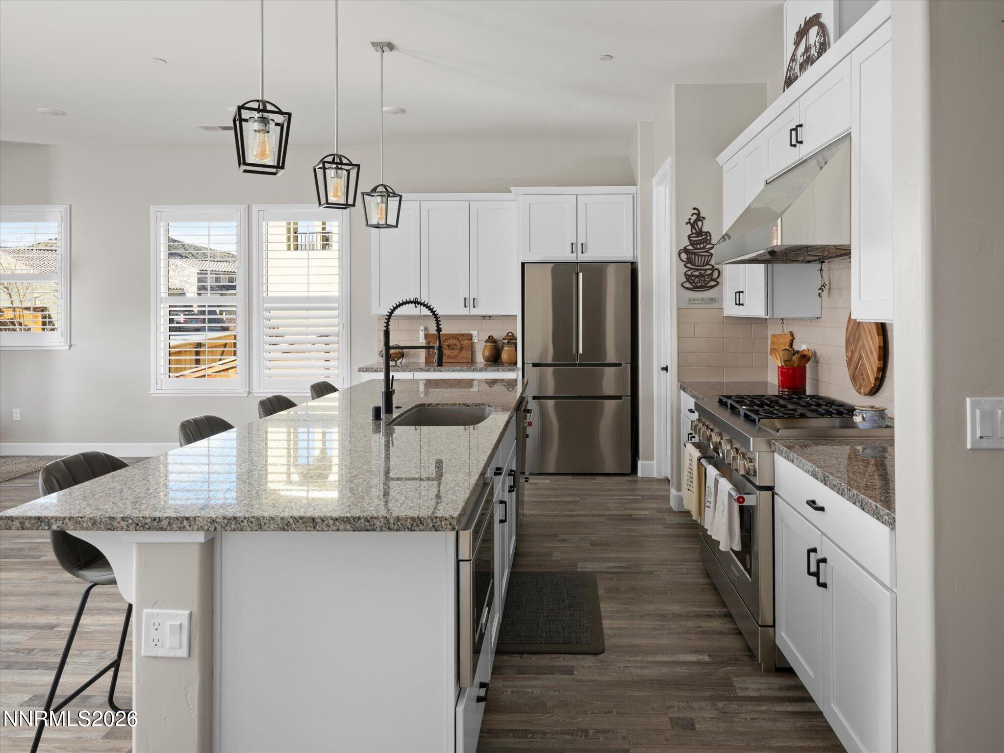 415 Gooseberry Drive Reno, NV 89523 - Photo 8 of 32 a kitchen with stainless steel appliances granite countertop a sink refrigerator and cabinets