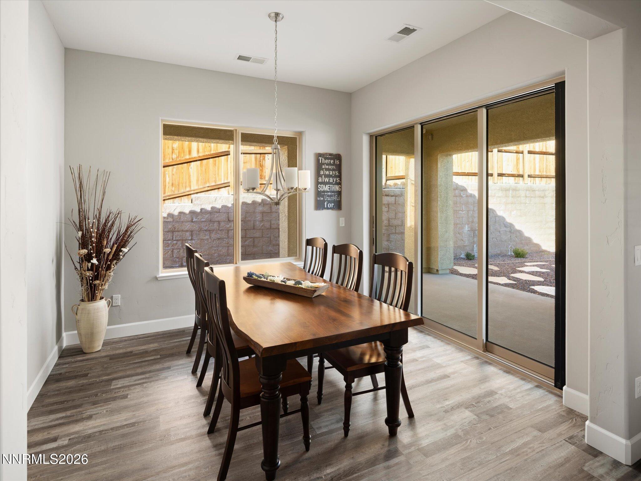 415 Gooseberry Drive Reno, NV 89523 - Photo 10 of 32 a view of a dining room with furniture window and wooden floor