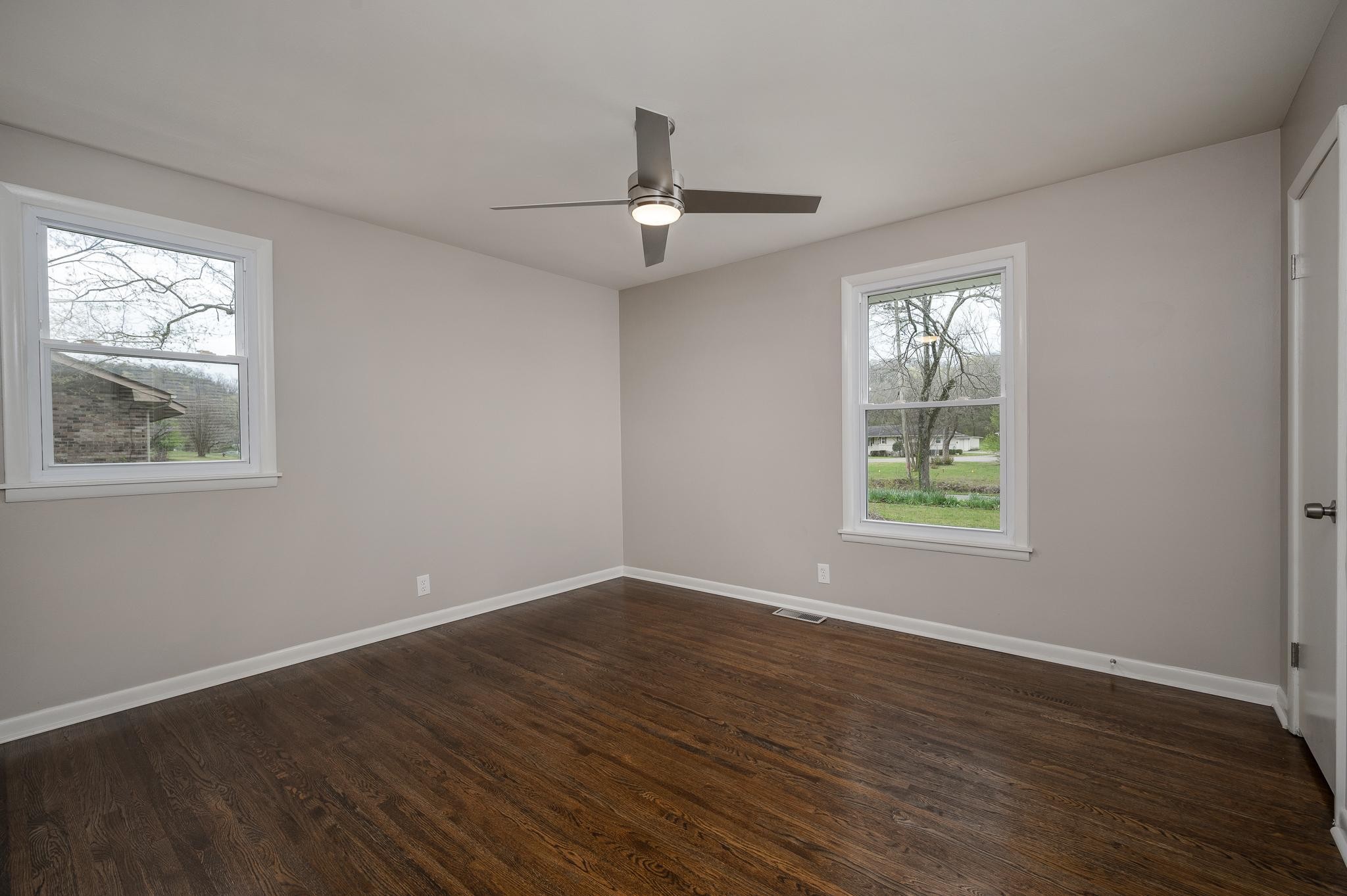 1080 Slaters Creek Road Goodlettsville, TN 37072 - Photo 13 of 22 a view of an empty room with wooden floor and a window