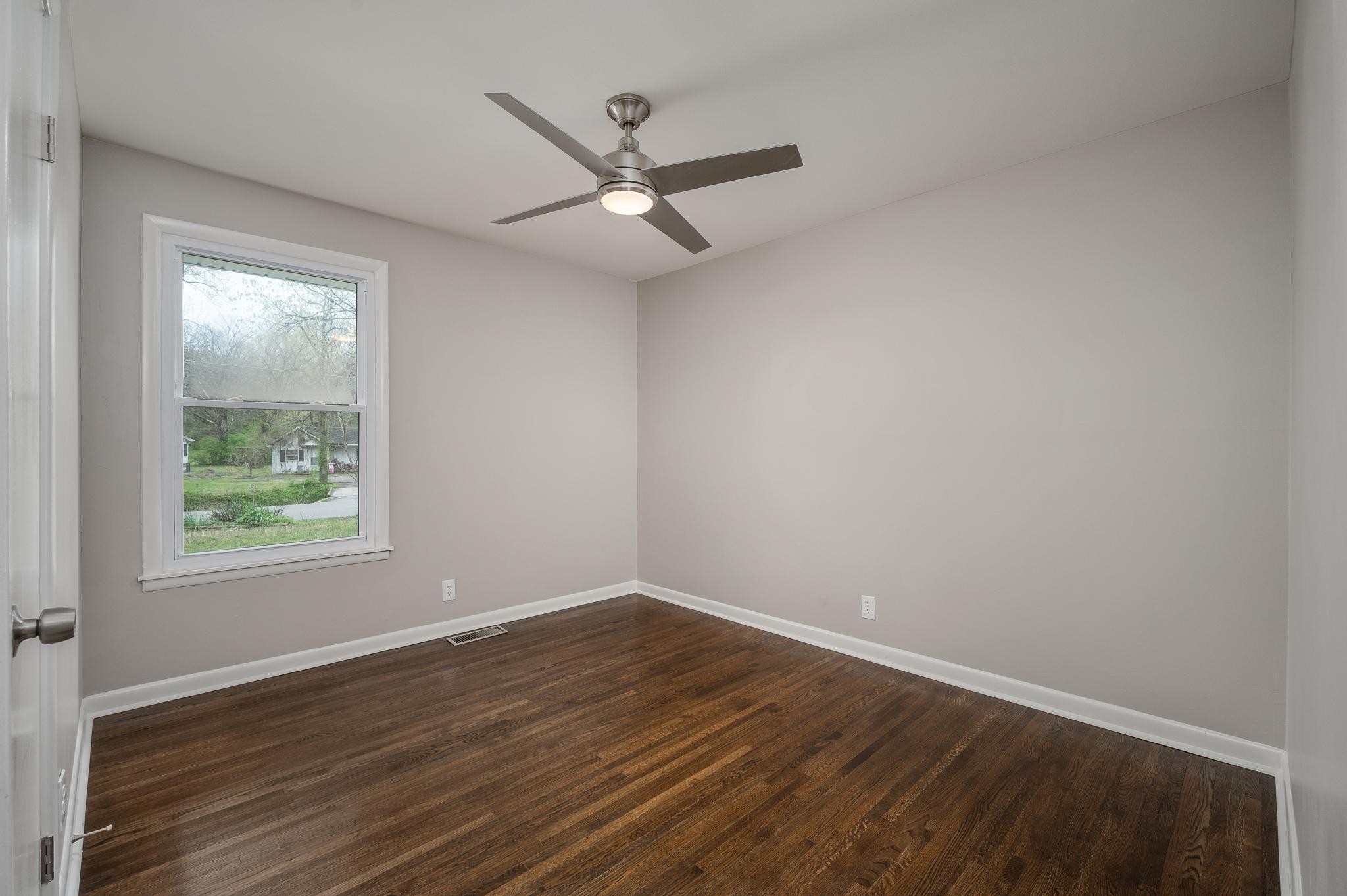 1080 Slaters Creek Road Goodlettsville, TN 37072 - Photo 14 of 22 an empty room with wooden floor fan and windows