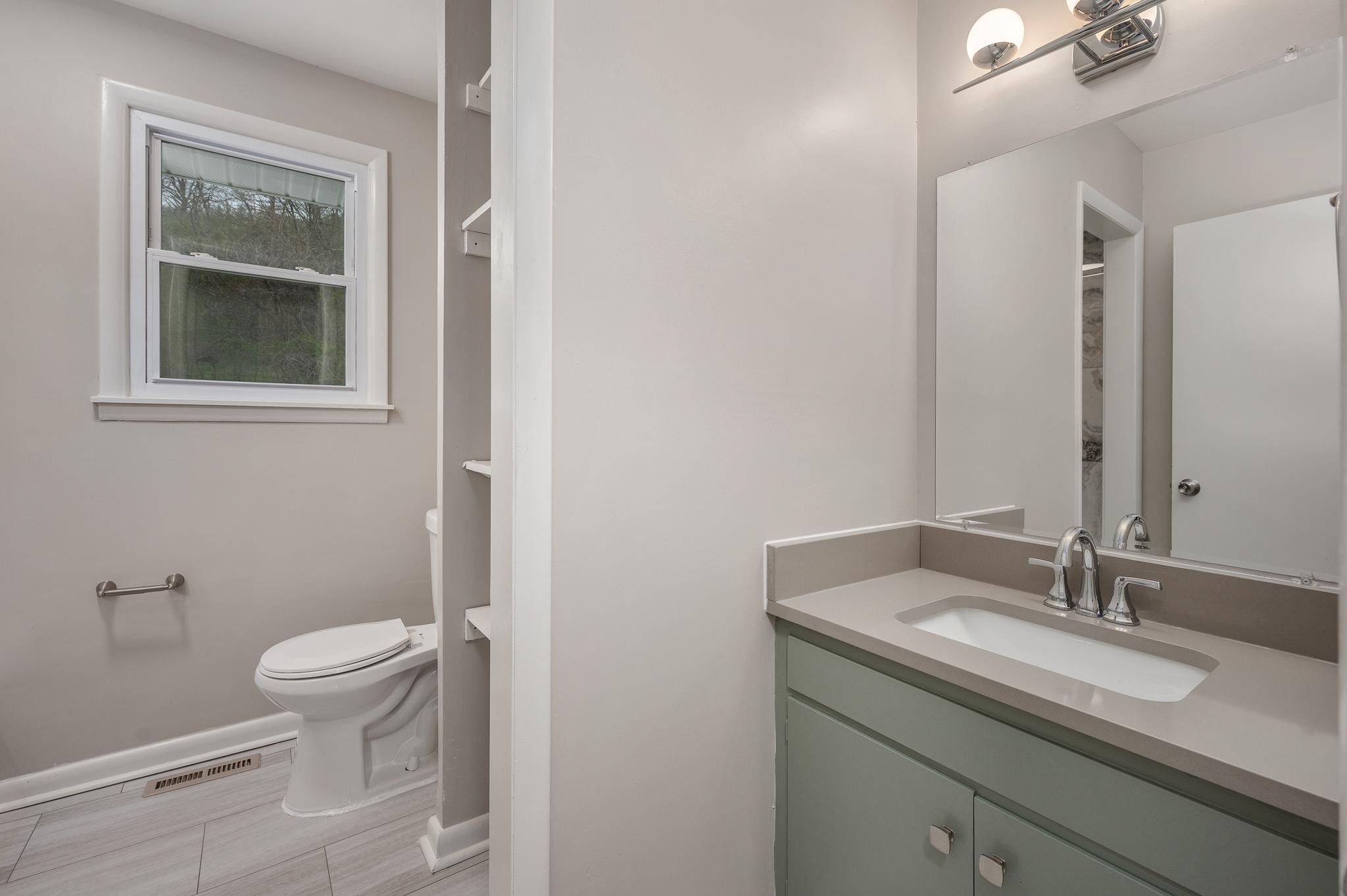 1080 Slaters Creek Road Goodlettsville, TN 37072 - Photo 16 of 22 a bathroom with a granite countertop sink toilet and mirror