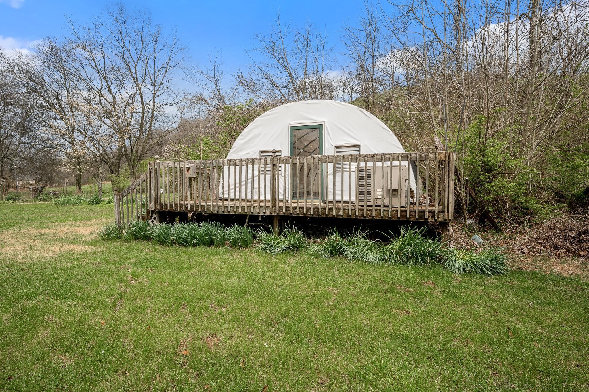 1080 Slaters Creek Road Goodlettsville, TN 37072 - Photo 19 of 22 a view of a house with a wooden deck and a yard