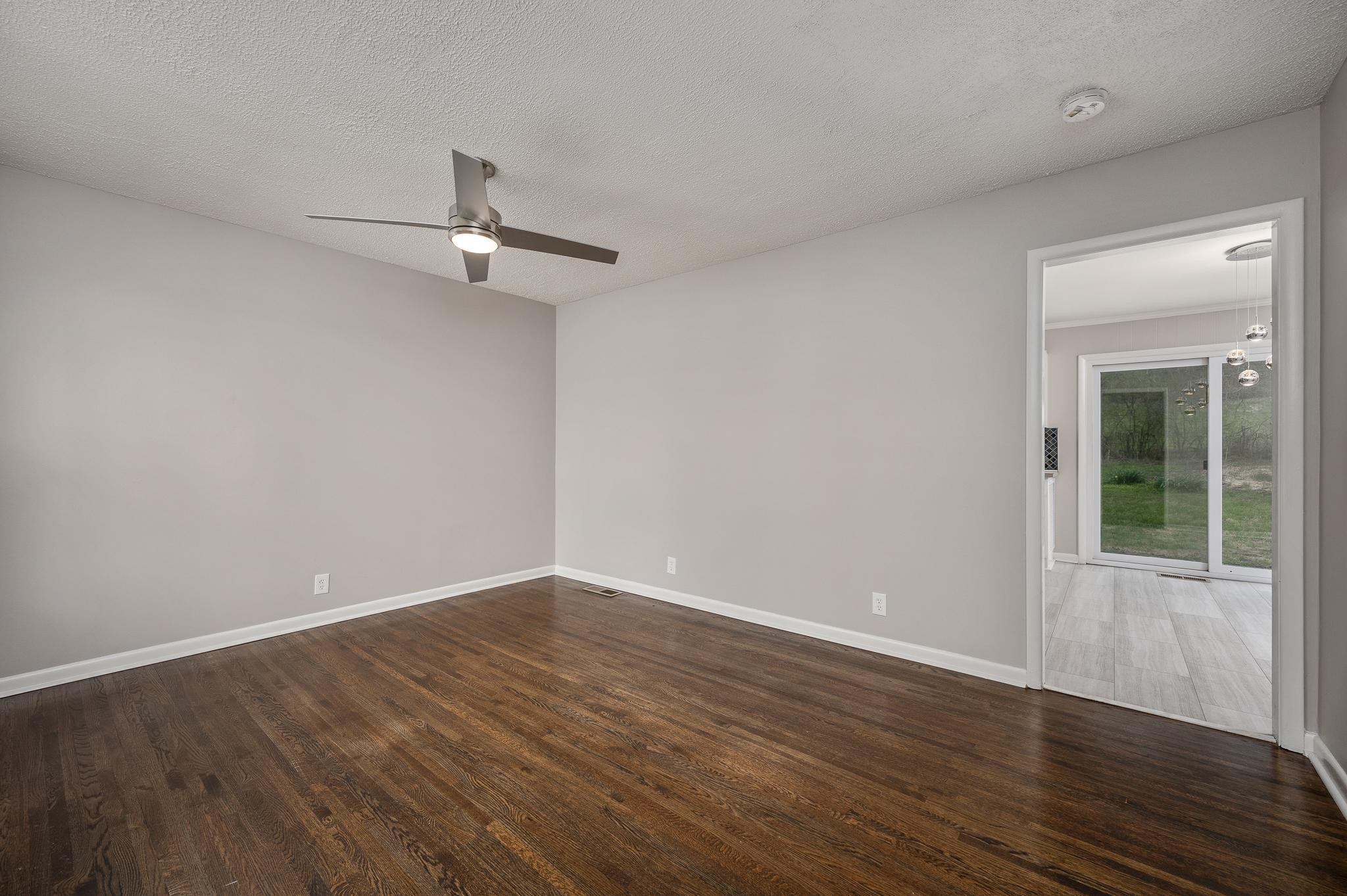 1080 Slaters Creek Road Goodlettsville, TN 37072 - Photo 6 of 22 a view of an empty room with wooden floor ceiling fan