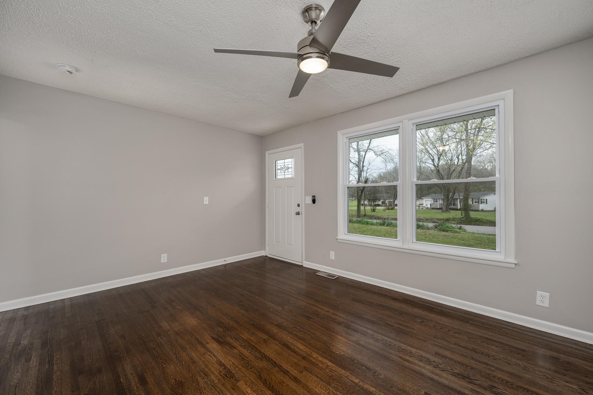 1080 Slaters Creek Road Goodlettsville, TN 37072 - Photo 7 of 22 a view of an empty room with wooden floor and a window