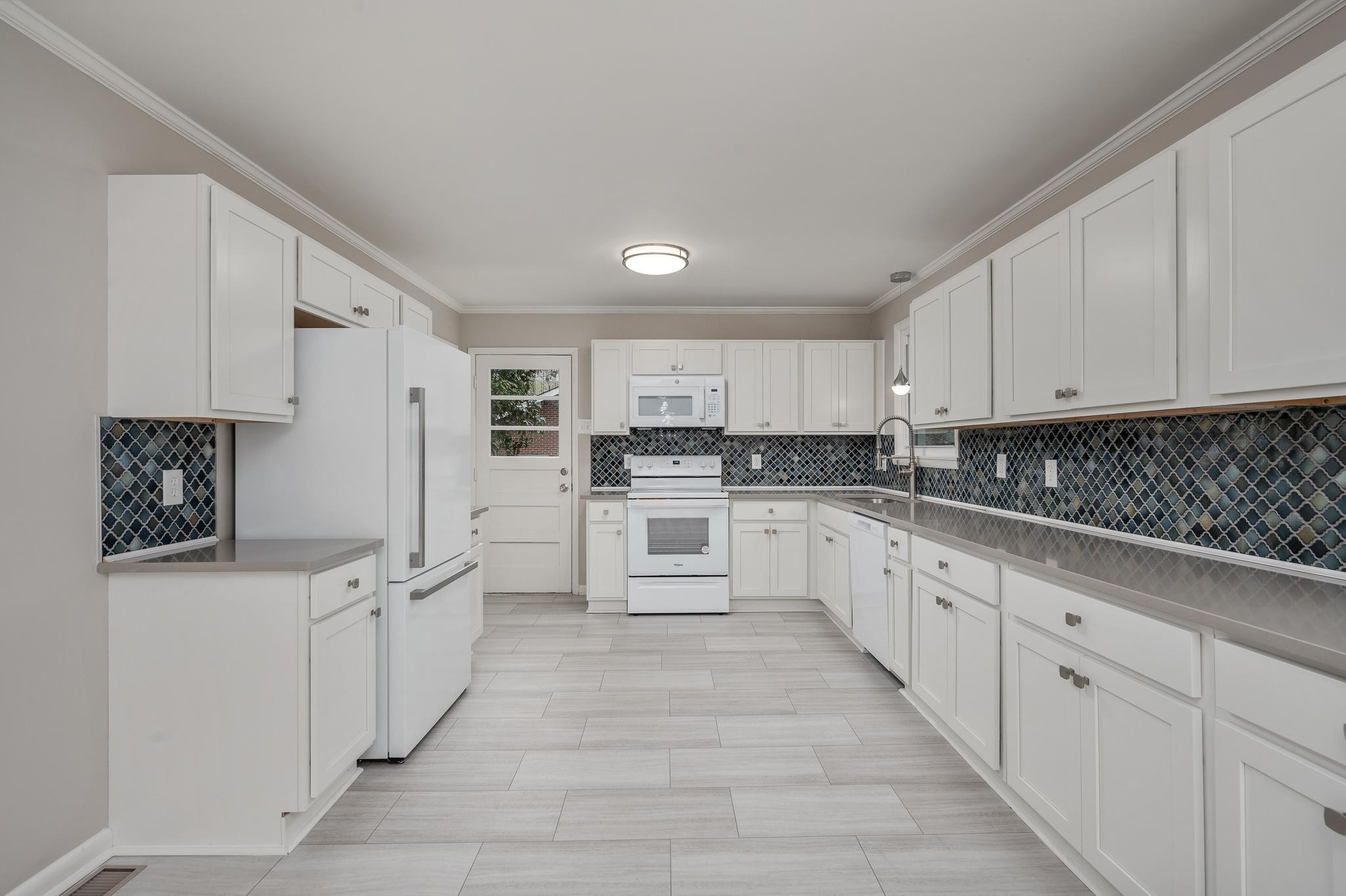 1080 Slaters Creek Road Goodlettsville, TN 37072 - Photo 8 of 22 a large white kitchen with cabinets and stainless steel appliances