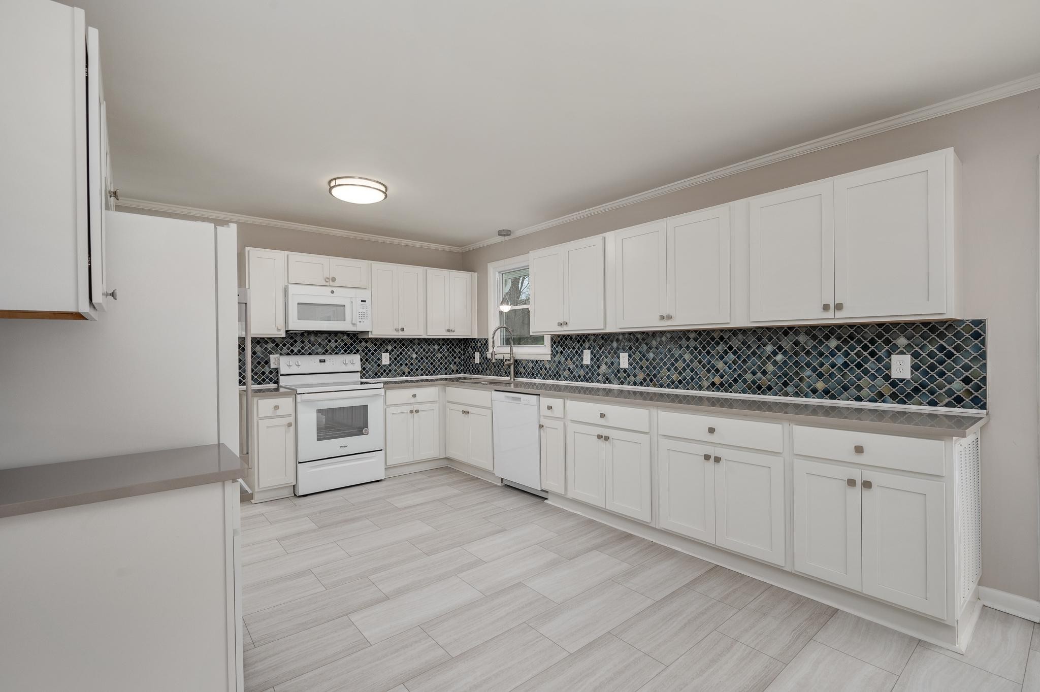 1080 Slaters Creek Road Goodlettsville, TN 37072 - Photo 9 of 22 a kitchen with granite countertop white cabinets and white appliances