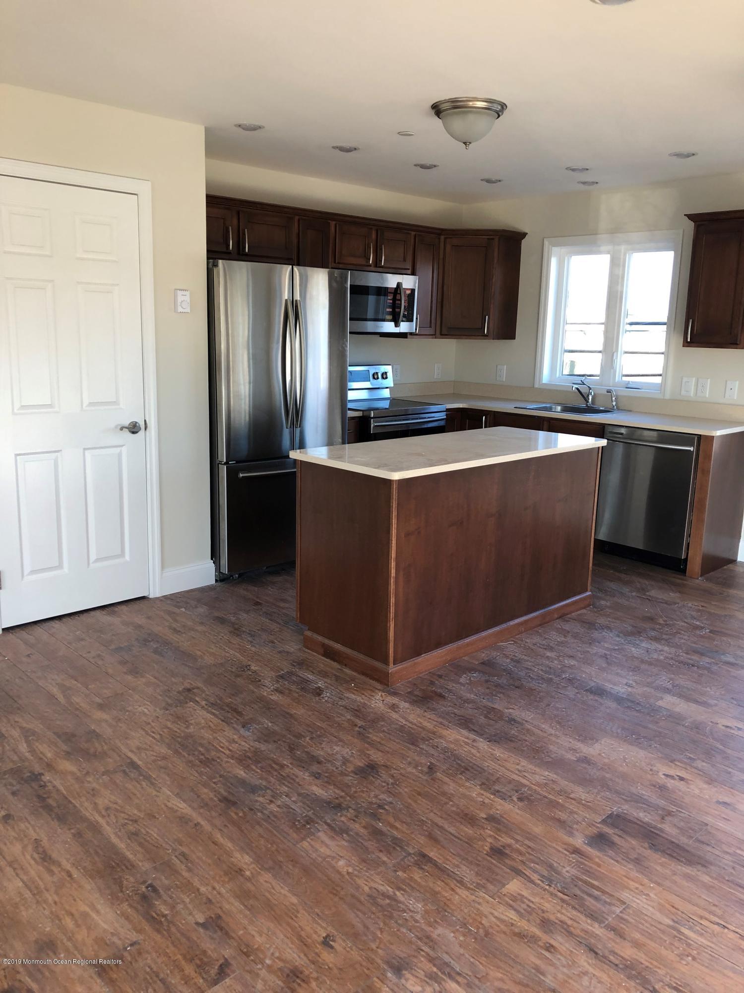 179 First Avenue, Unit B Atlantic Highlands, NJ 07716 - Photo 1 of 3 a large kitchen with stainless steel appliances granite countertop a stove a sink and a refrigerator