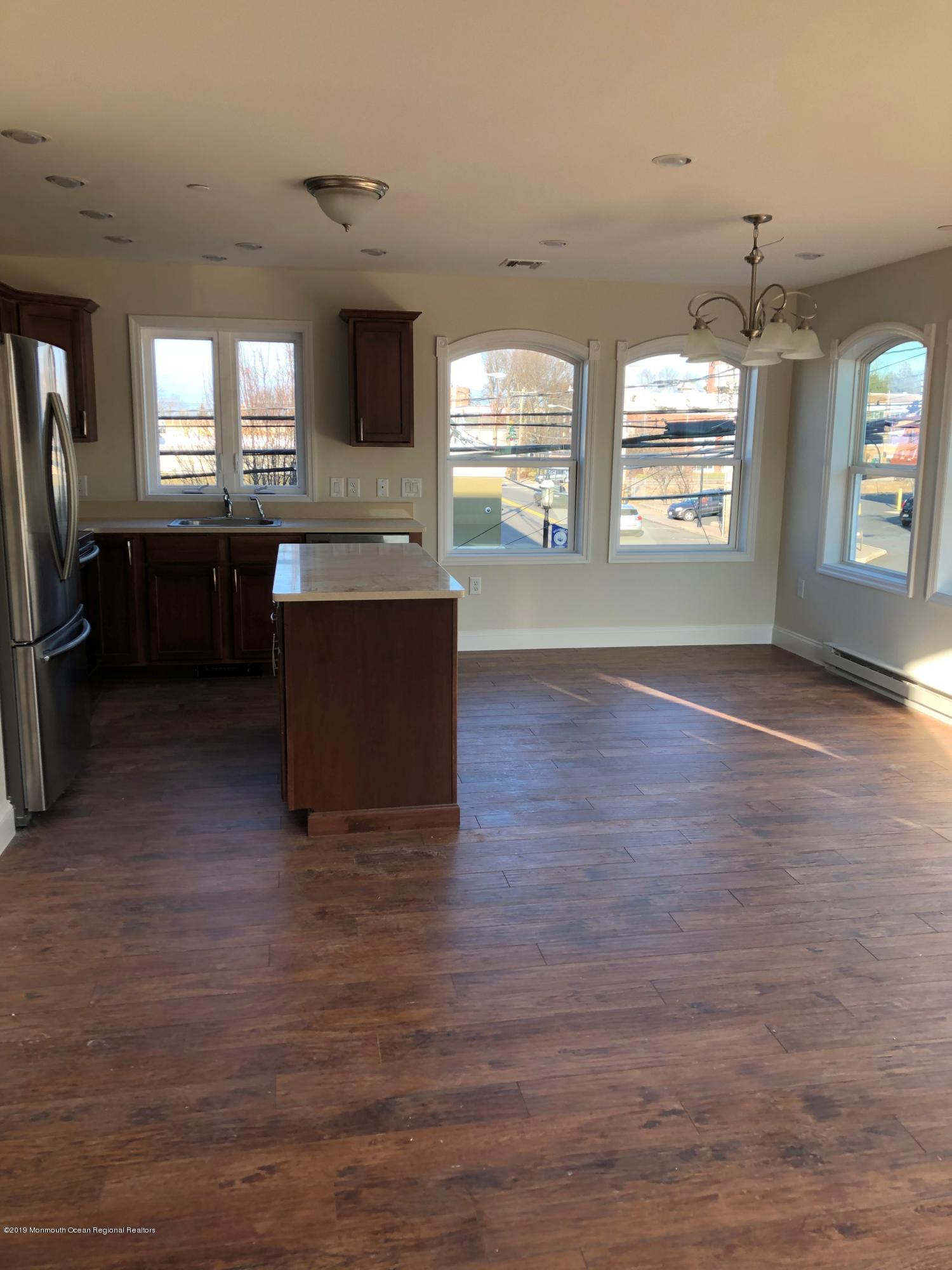 179 First Avenue, Unit B Atlantic Highlands, NJ 07716 - Photo 2 of 3 an empty room with windows wooden floor and windows