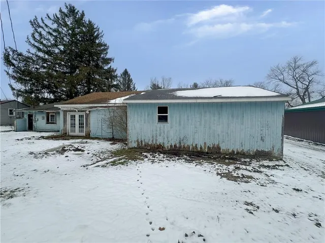 a view of a house with a snow in the background