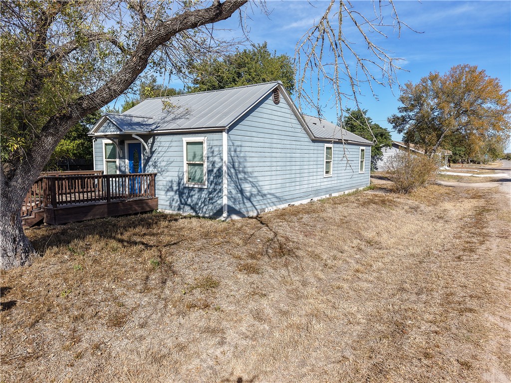 305 East Tullos Street Three Rivers, TX 78071 - Photo 4 of 13 a view of a house with a yard and wooden fence