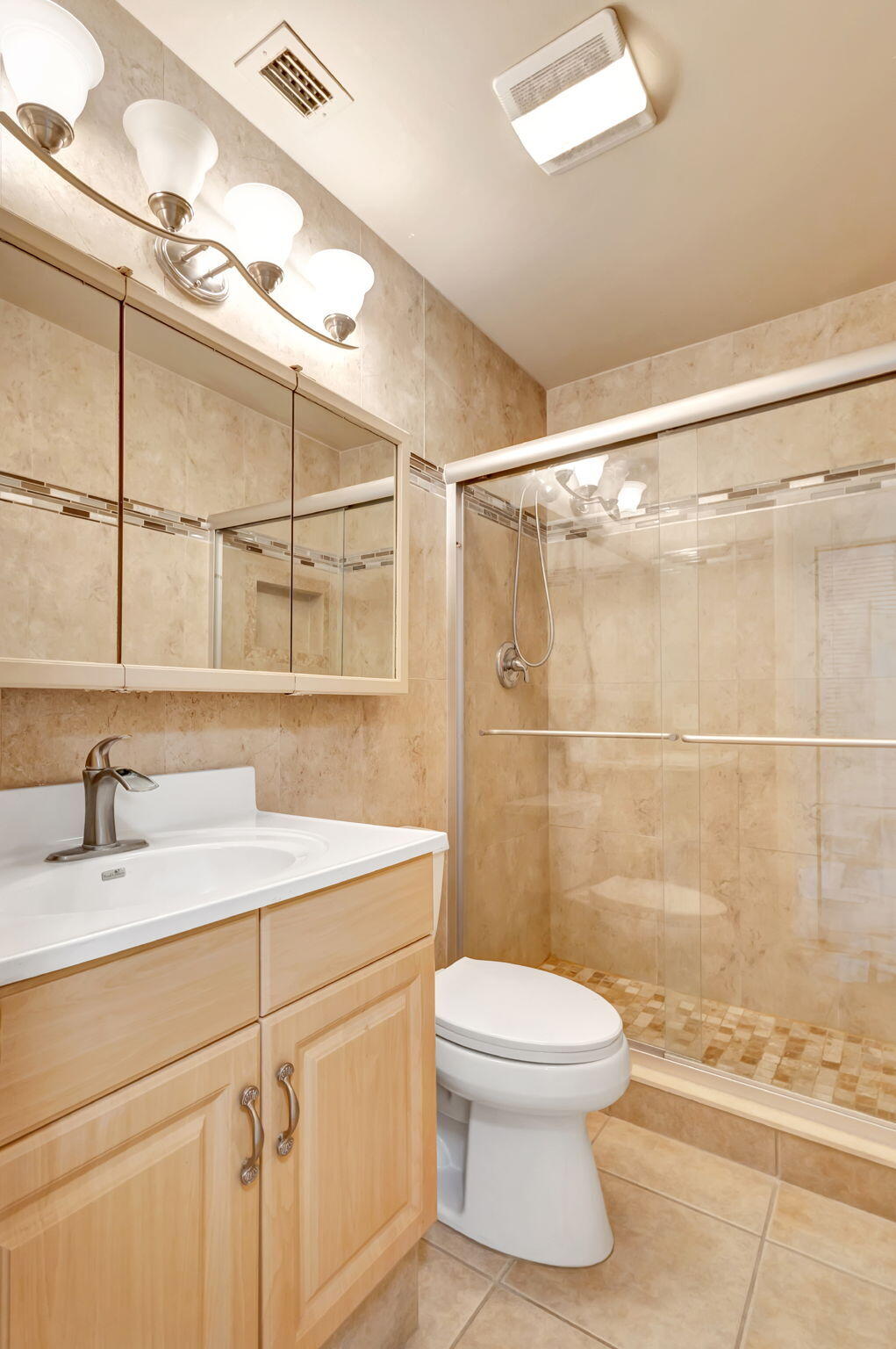 6458 Chasewood Drive, Unit E Jupiter, FL 33458 - Photo 14 of 33 a bathroom with a sink toilet vanity and shower