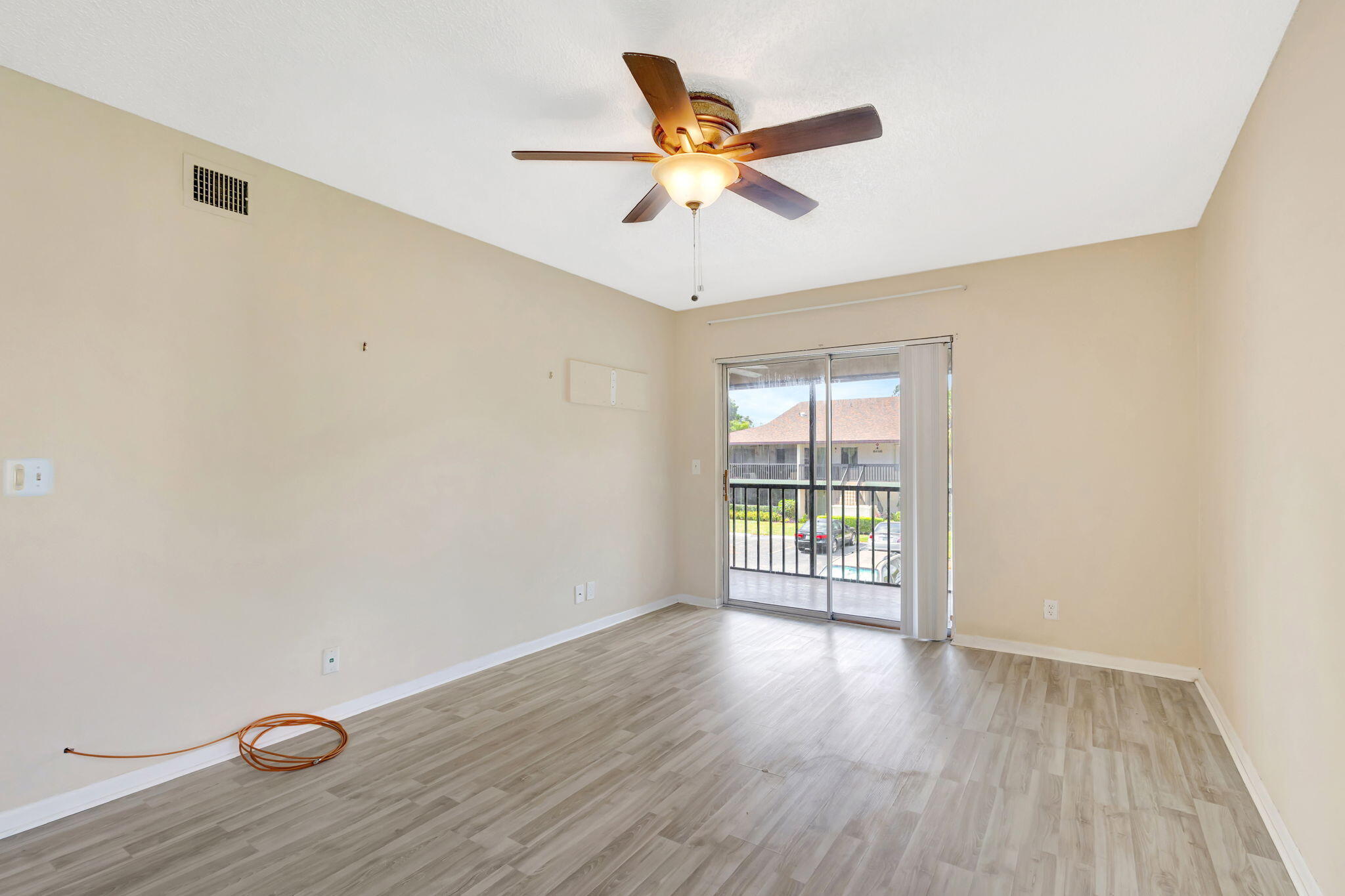 6458 Chasewood Drive, Unit E Jupiter, FL 33458 - Photo 18 of 33 wooden floor in an empty room with a window