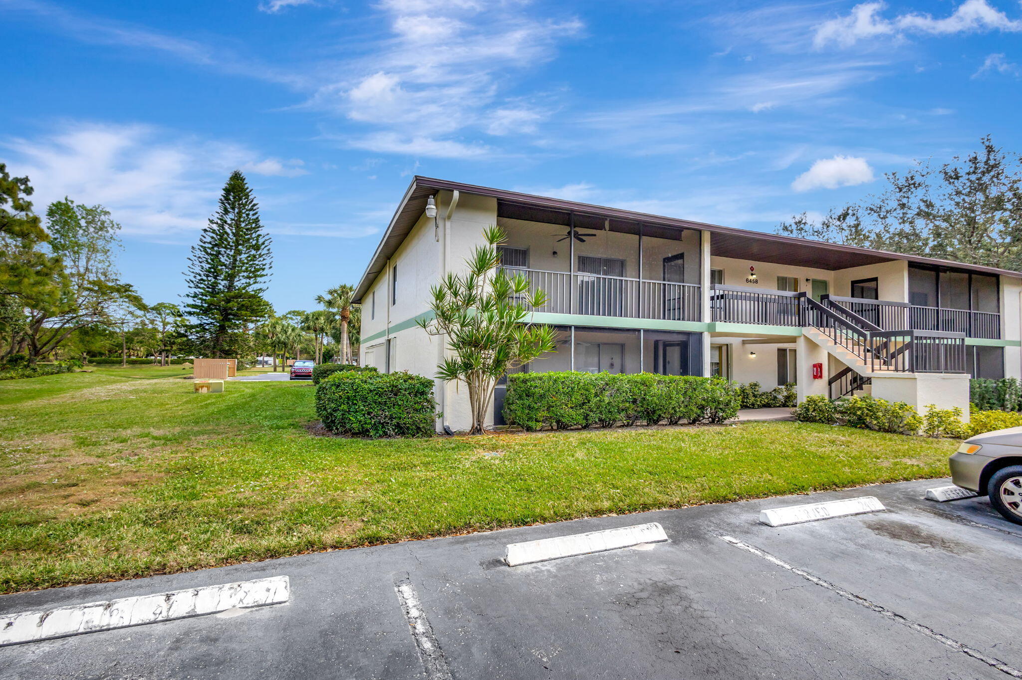 6458 Chasewood Drive, Unit E Jupiter, FL 33458 - Photo 23 of 33 a front view of a house with a yard