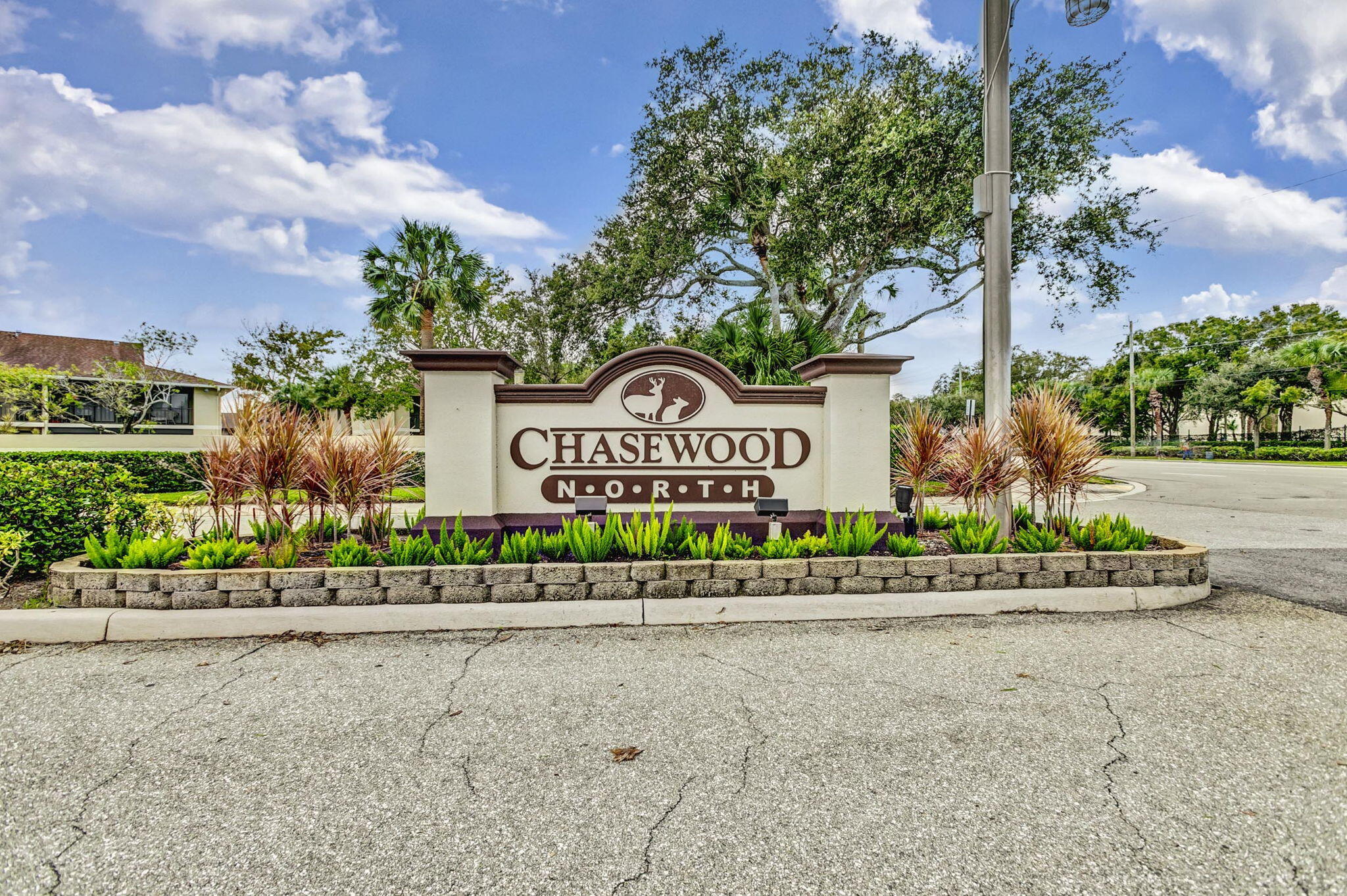 6458 Chasewood Drive, Unit E Jupiter, FL 33458 - Photo 32 of 33 a view of a street with a building in the background