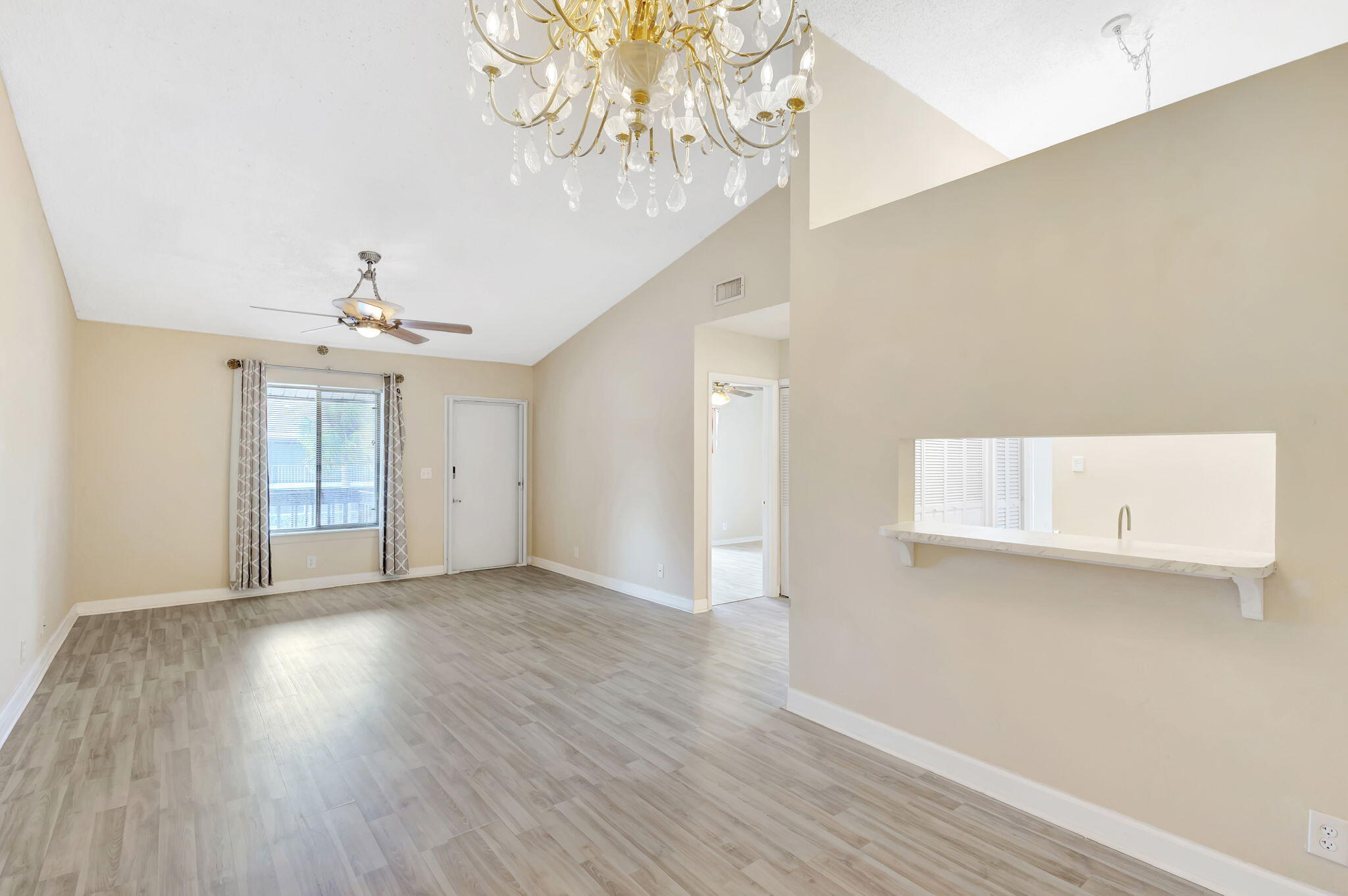 6458 Chasewood Drive, Unit E Jupiter, FL 33458 - Photo 6 of 33 wooden floor in an empty room with a window