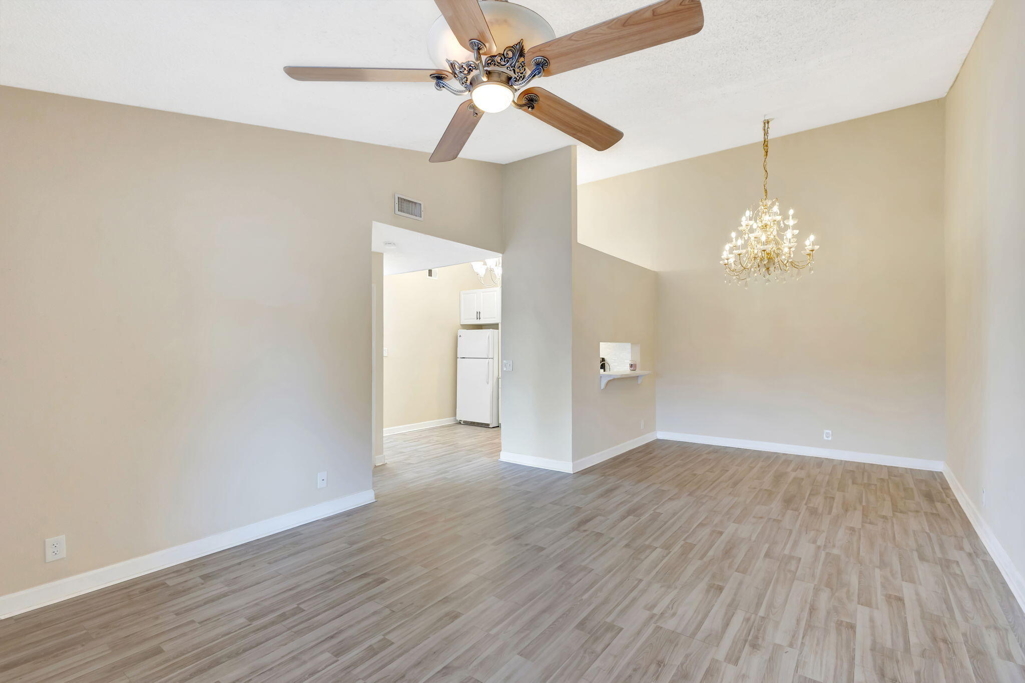 6458 Chasewood Drive, Unit E Jupiter, FL 33458 - Photo 7 of 33 a view of a chandelier fan and wooden floor