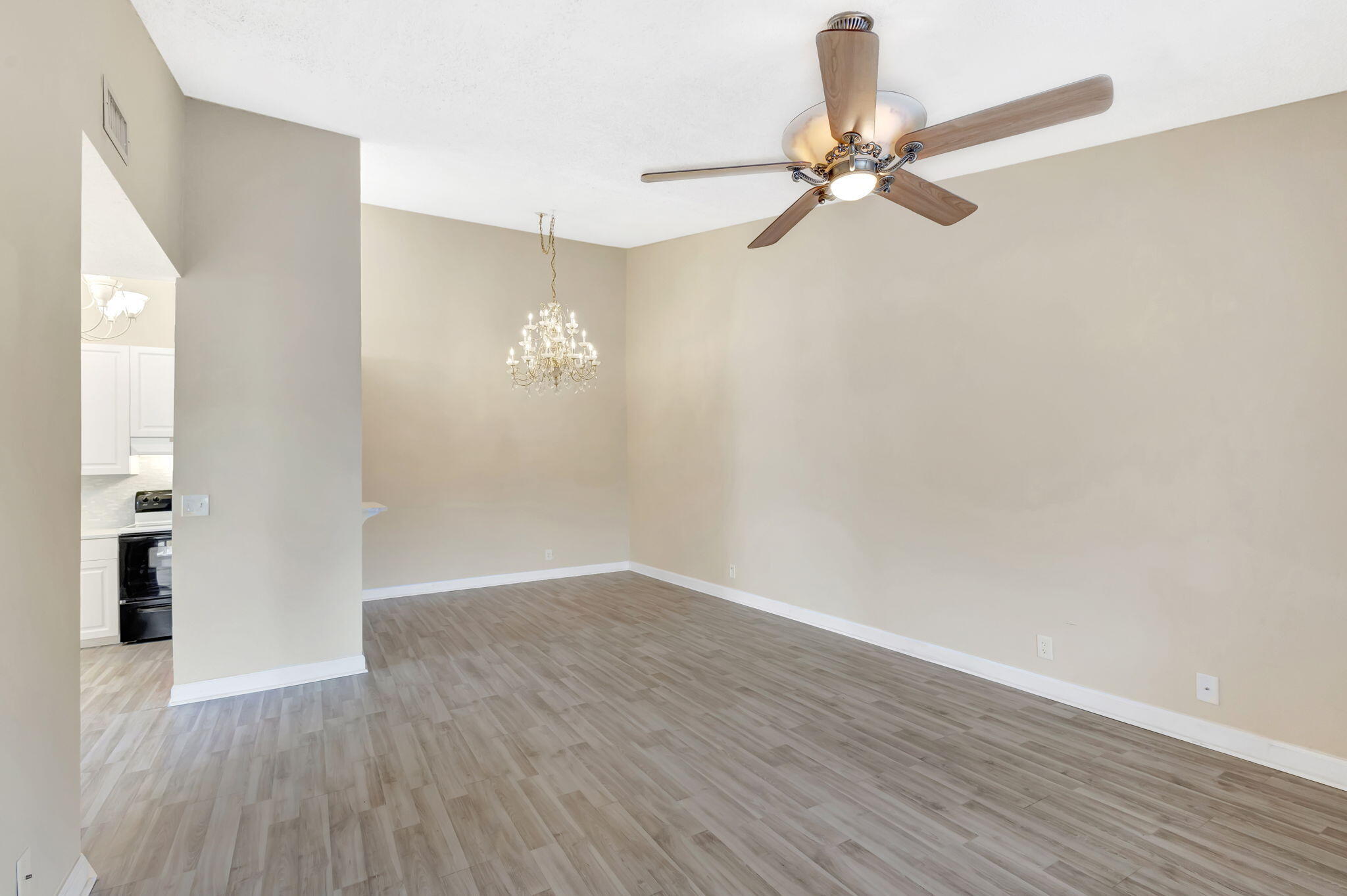 6458 Chasewood Drive, Unit E Jupiter, FL 33458 - Photo 8 of 33 a view of a room with wooden floor and ceiling fan