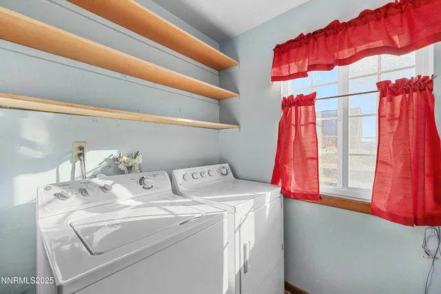 a view of a dry yard with wooden fence