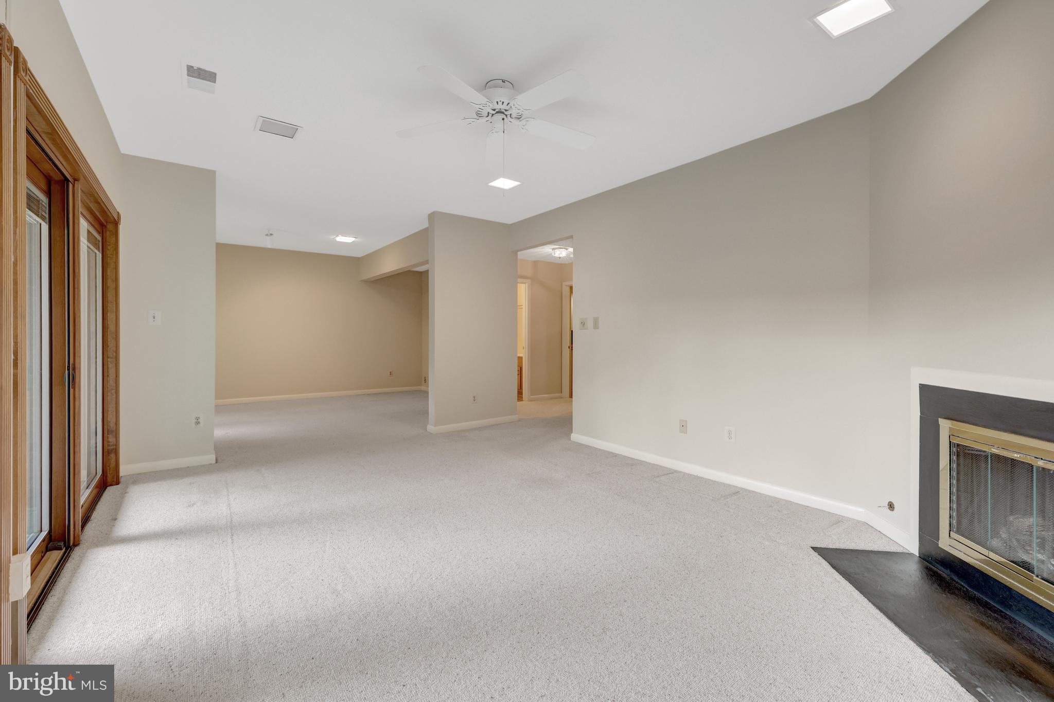 11088 Glade Court Reston, VA 20191 - Photo 74 of 75 a view of an empty room with a fireplace and a window