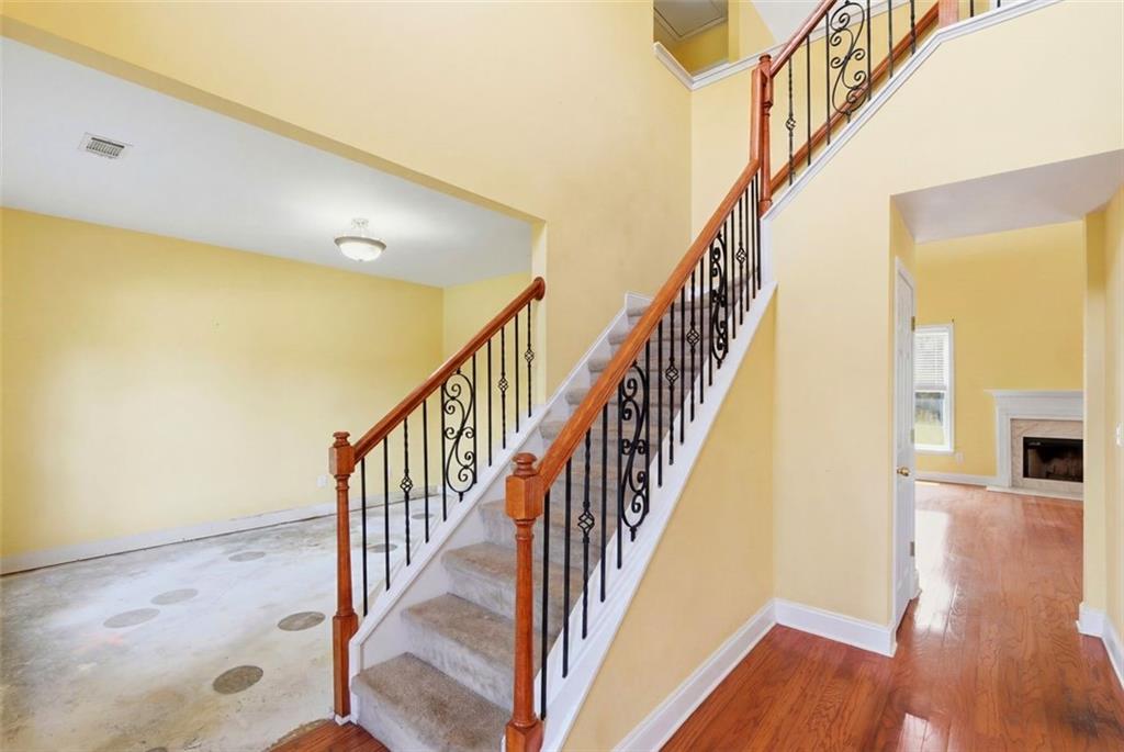 3420 Bulloch Lake Road Loganville, GA 30052 - Photo 8 of 57 a view of staircase with wooden floor and staircase