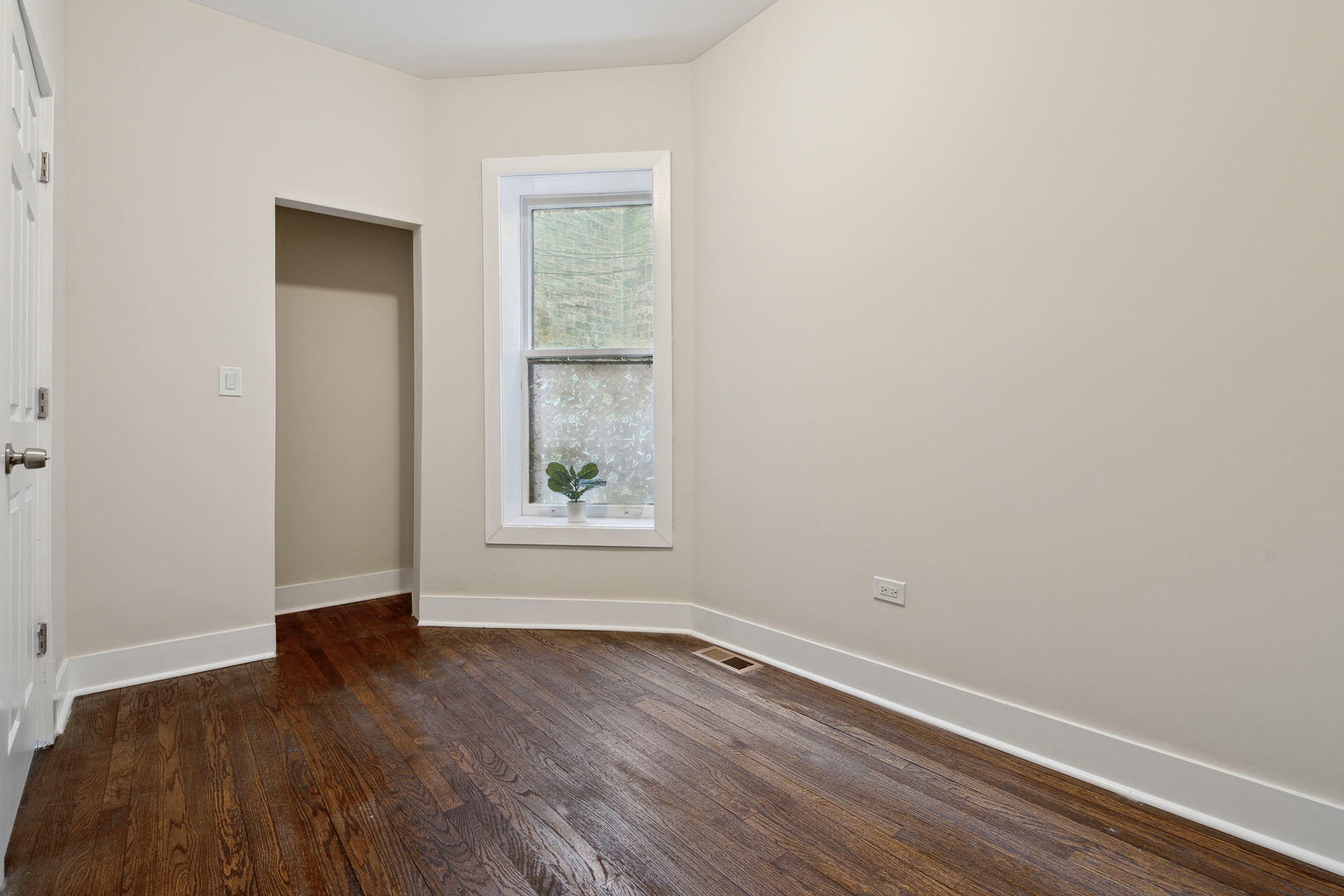 6826 South Prairie Avenue, Unit 1 Chicago, IL 60637 - Photo 12 of 20 an empty room with wooden floor and windows