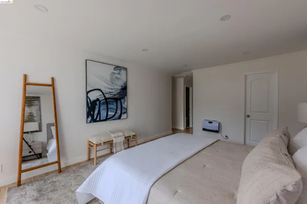 a bedroom with a bed and a night stand