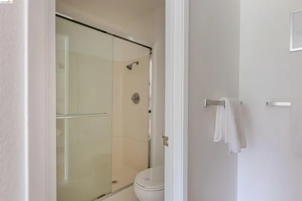 a bedroom with a bed and a refrigerator