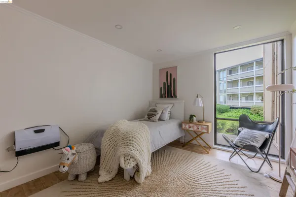 a living room with furniture a desk and chair with wooden floor