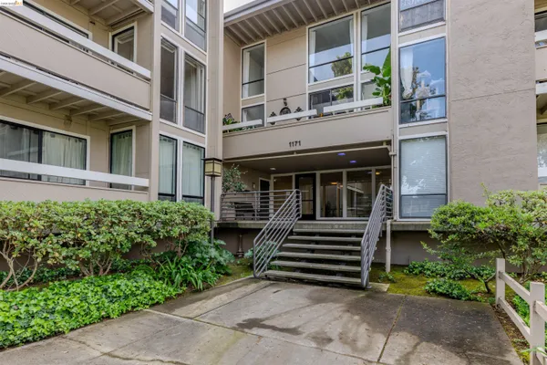 a front view of a building with a garden