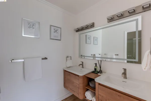 a bedroom with a bed and a painting on the wall