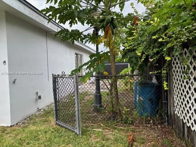 a view of a house with a tree in the yard