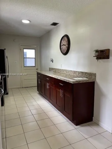 a bathroom with a granite countertop sink a mirror and vanity