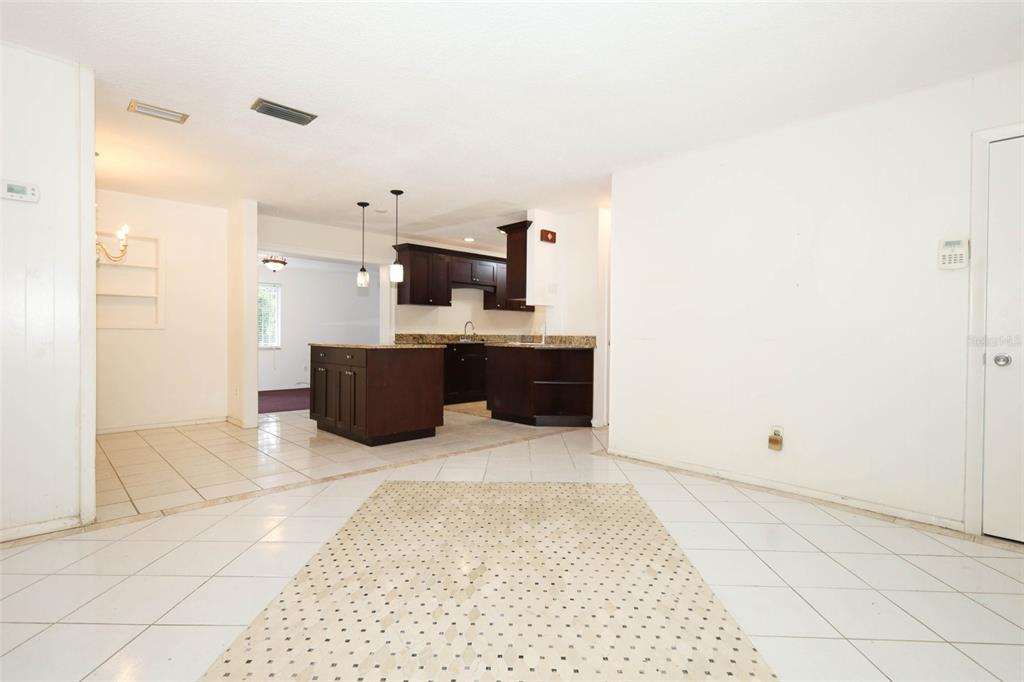 124 Salem Street Altamonte Springs, FL 32701 - Photo 19 of 45 a room with kitchen island a sink a stove and a refrigerator
