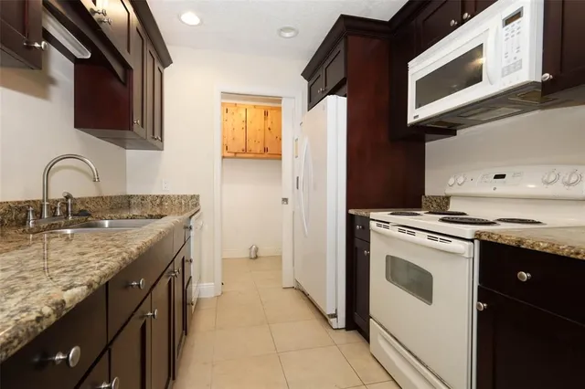 a kitchen with stainless steel appliances granite countertop a stove and a microwave